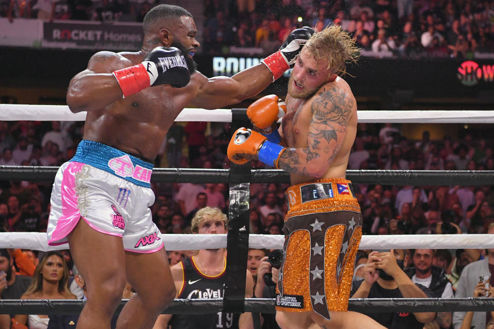 Jake Paul (pictured right) punches Tyron Woodley (pictured left) in their cruiserweight bout.