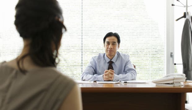 Businessman and businesswoman talking in office