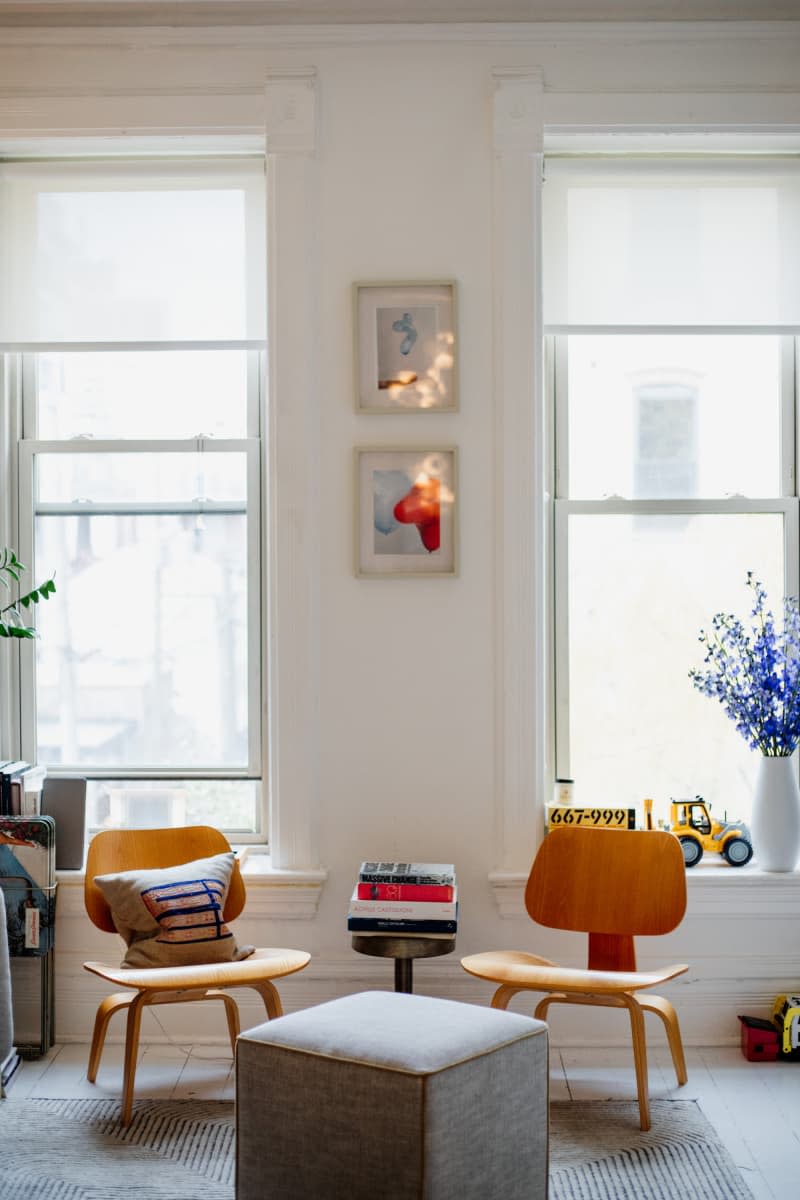 Wooden accent chairs in apartment living room.