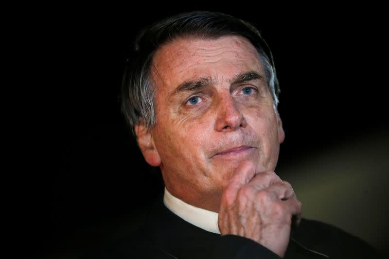 Brazil's President Jair Bolsonaro speaks with journalists as he arrives at Alvorada Palace, amid the coronavirus disease (COVID-19) outbreak, in Brasilia