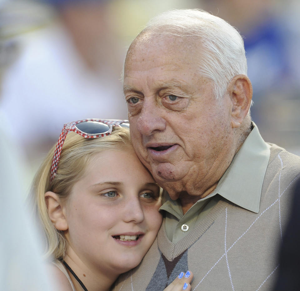 Hall of Fame and former Los Angeles Dodgers manager Tommy Lasorda passed away at the age of 93. Los Angeles Dodgers former manager Tommy Lasorda with owner Mark Walters daughter prior to a baseball game between the San Francisco Giants and the Los Angeles Dodgers on Tuesday, Aug. 22, 2012 in Los Angeles. (Keith Birmingham/The Orange County Register via AP)