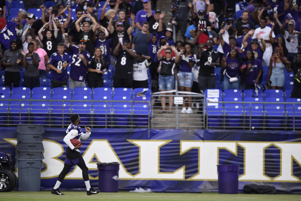 Baltimore Ravens' Marlon Humphreys looks to fans before throwing an autographed football, after practice at NFL football training camp Saturday, July 31, 2021, in Baltimore. (AP Photo/Gail Burton)