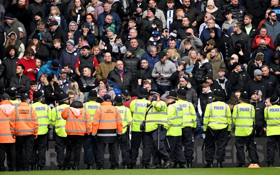 West Brom v Wolves crowd trouble: police use batons as players are called off the pitch