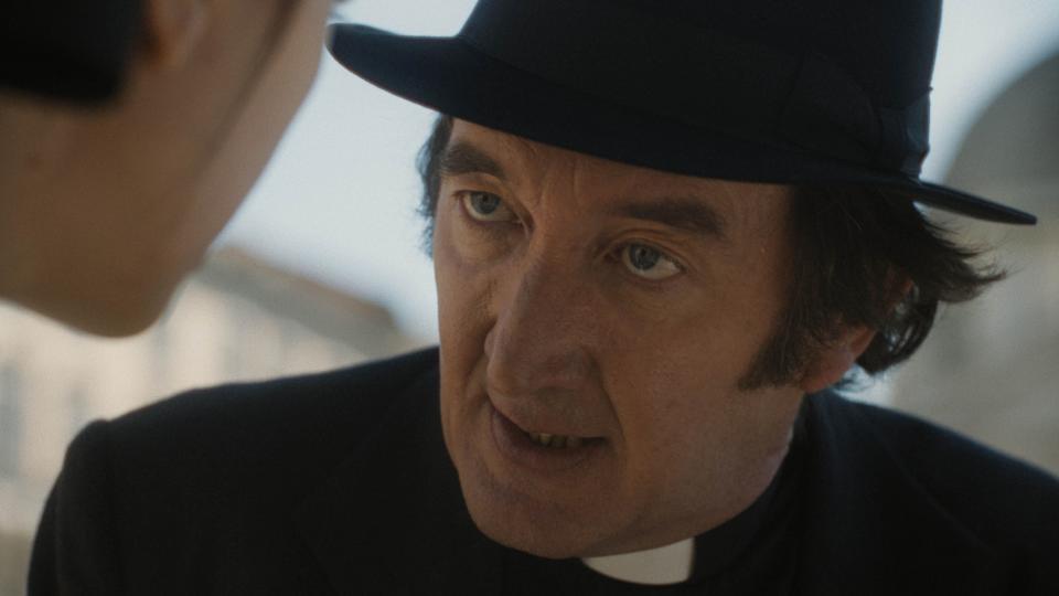 Father Brennan (Ralph Ineson) warns of plans to birth the Antichrist in "The First Omen."