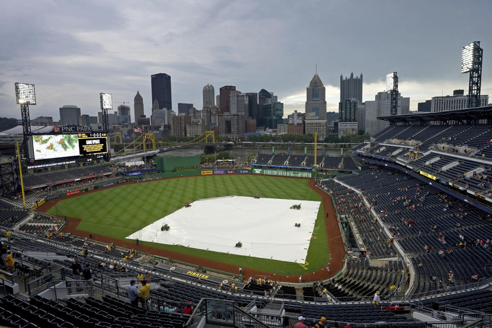 Fans begin to leave PNC Park after it was announced a baseball game between the Pittsburgh Pirates and the Cincinnati Reds had been postponed due to inclement weather in Pittsburgh, Saturday, Aug. 12, 2023. (AP Photo/Matt Freed)