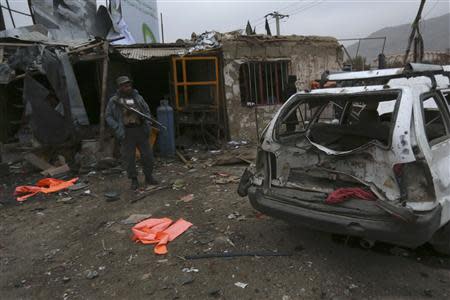 A policeman stands guard at the scene of a suicide attack in Kabul, November 16, 2013. REUTERS/Omar Sobhani