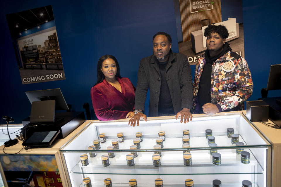 Roland Conner, son Darius, and wife Patricia are photographed at the "pop up" cannabis dispensary location of their business Smacked, Monday, Jan. 23, 2023, in New York. The store launch on Tuesday is New York's first legal cannabis dispensary run by someone previously criminalized by the state’s prohibitionist cannabis laws. (AP Photo/John Minchillo)