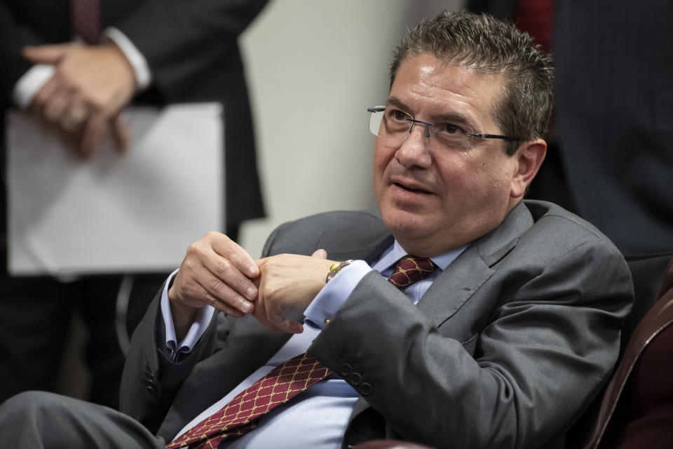 FILE - Washington Redskins owner Dan Snyder listens to head coach Ron Rivera during a news conference at the team's NFL football training facility, in Ashburn, Va., Jan. 2, 2020. The ranking Democrat on the U.S. House Committee on Oversight and Reform is asking the Republican chair in charge to refer former Washington Commanders owner Dan Snyder to the Department of Justice for lying under oath. (AP Photo/Alex Brandon, File)