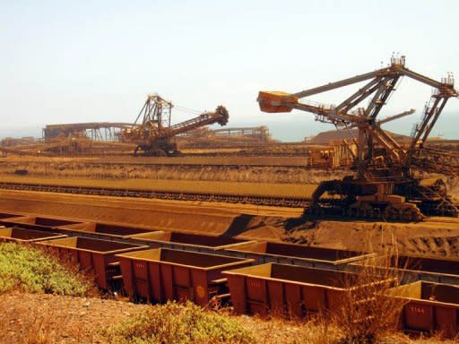 File photo of remote-controlled stackers and reclaimers moving iron ore to rail cars at Rio Tinto's Port Dampier operations in Western Australia's Pilbara region. Iron ore, mostly from the Pilbara region in Western Australia, currently represents nearly 80 percent of the company's earnings