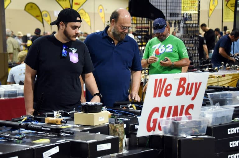 Gun enthusiasts attend a show at the Dade County Youth Fairgrounds in Miami, Florida, on February 17, 2018, three days after a mass shooting at a high school 30 miles (48 km) away left 17 people dead