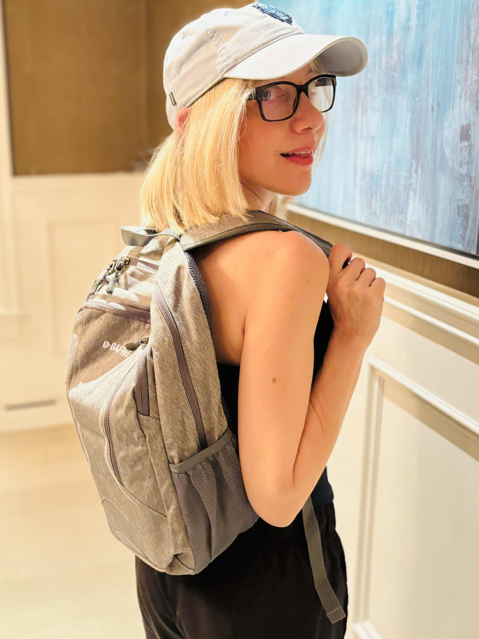 blonde woman in baseball cap wearing G4Free 16L Small Hiking Backpack, Compact Travel Backpack Lightweight Daypack Waterproof for Men Women School Outdoor