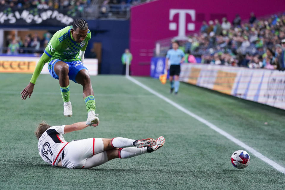 Seattle Sounders midfielder Léo Chú, top, jumps up to avoid a tackle by FC Dallas midfielder Paxton Pomykal (19) during the first half of an MLS playoff soccer match Monday, Oct. 30, 2023, in Seattle. (AP Photo/Lindsey Wasson)