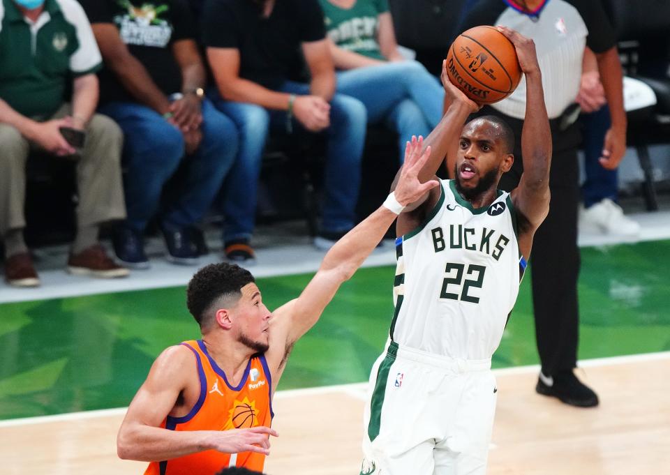 Khris Middleton set a playoff career-high with 40 points to help the Bucks overcome 42 from Devin Booker.