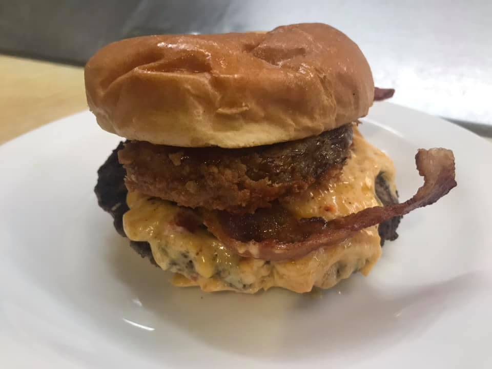 The Depot slim burger with pimento cheese, bacon, beef and more.