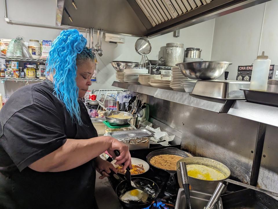 Riegna Breaux cooking breakfast items inside The Dehn Bar.