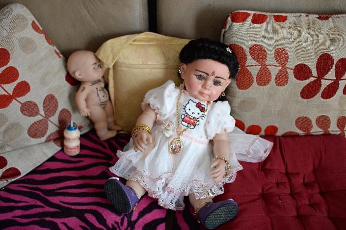 Plastic dolls are now taking their seats at restaurant tables, cinemas and even on airplanes in Thailand (AFP Photo/Christophe Archambault)