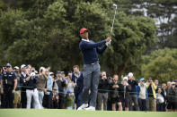 USA captain Tiger Woods hits an approach shot during a practice session ahead of the President's Cup Golf tournament in Melbourne, Tuesday, Dec. 10, 2019. (AP Photo/Andy Brownbill)