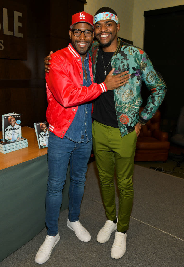 Karamo and Jason smiling and embracing