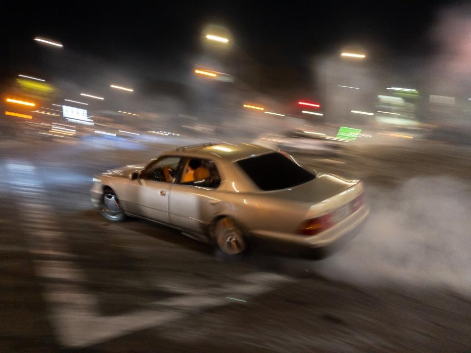 A blurred car with smoke