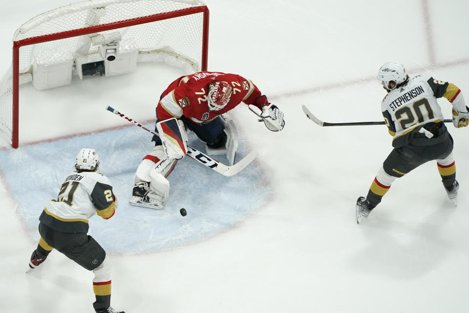 Florida Panthers goaltender Sergei Bobrovsky (72) defends the goal against Vegas Golden Knights center Brett Howden (21) and center Chandler Stephenson (20) during the first period of Game 3 of the NHL hockey Stanley Cup Finals, Friday, June 9, 2023, in Sunrise, Fla. (AP Photo/Lynne Sladky)