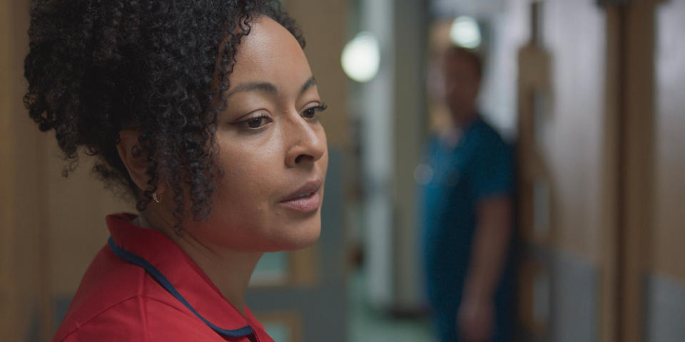 Donna looking sad while on shift in Holby ED.