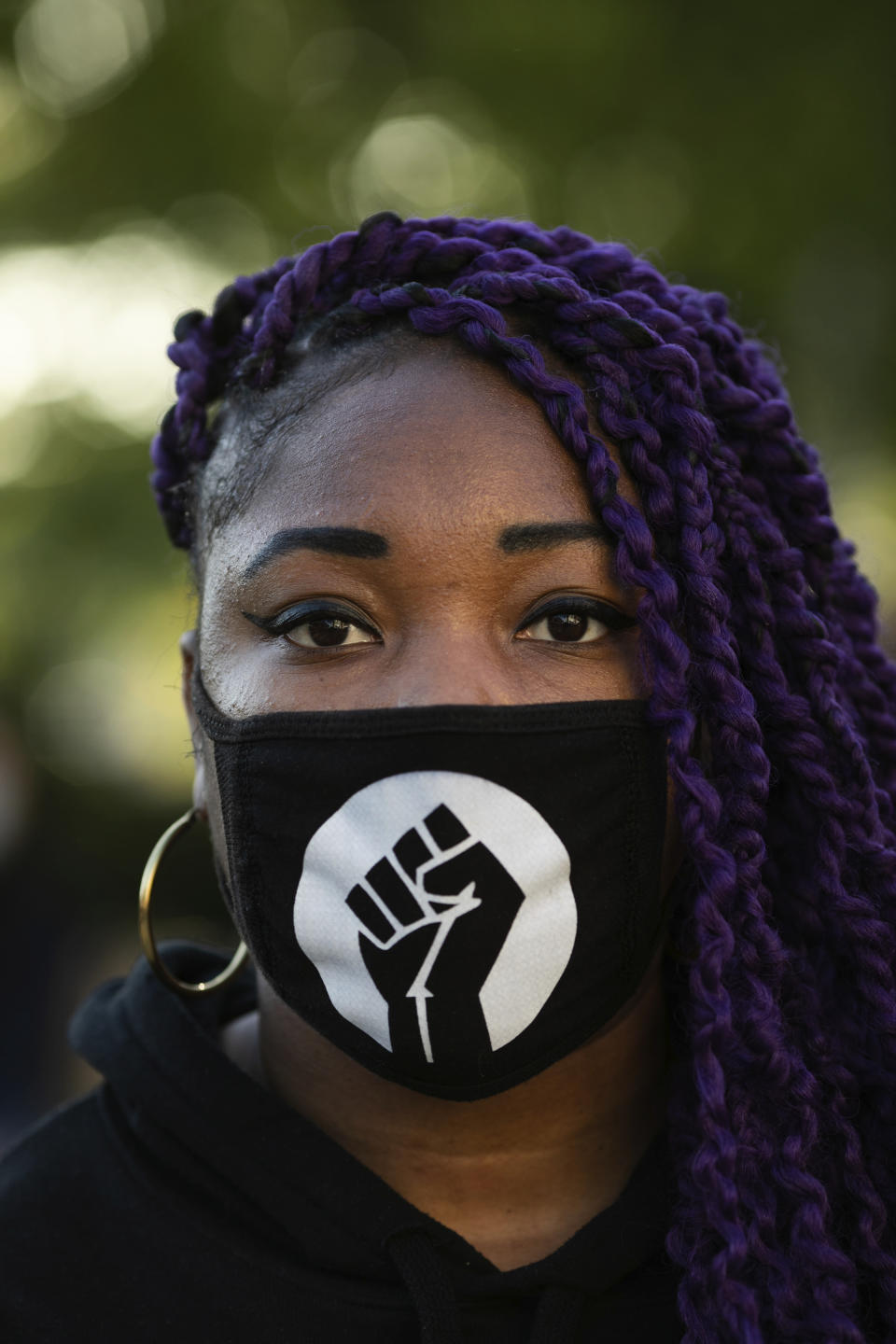 Victoria Machado wears a mask as she arrives to demonstrate at Barclays center on Sunday, May 31, 2020, in New York. Demonstrators took to the streets of New York City to protest the death of George Floyd, a black man who was killed in police custody in Minneapolis on May 25. (AP Photo/Kevin Hagen).