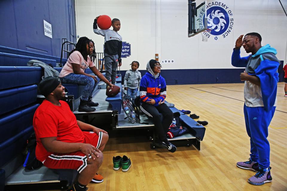 Marlin Dixon, right, spends time with family, from left,  brother Darryl Dixon; niece Niayah, 9; nephews Da’Kari, 8, and Jace, 3; and daughter Kamariya, 19, after playing basketball at Milwaukee Academy of Science.