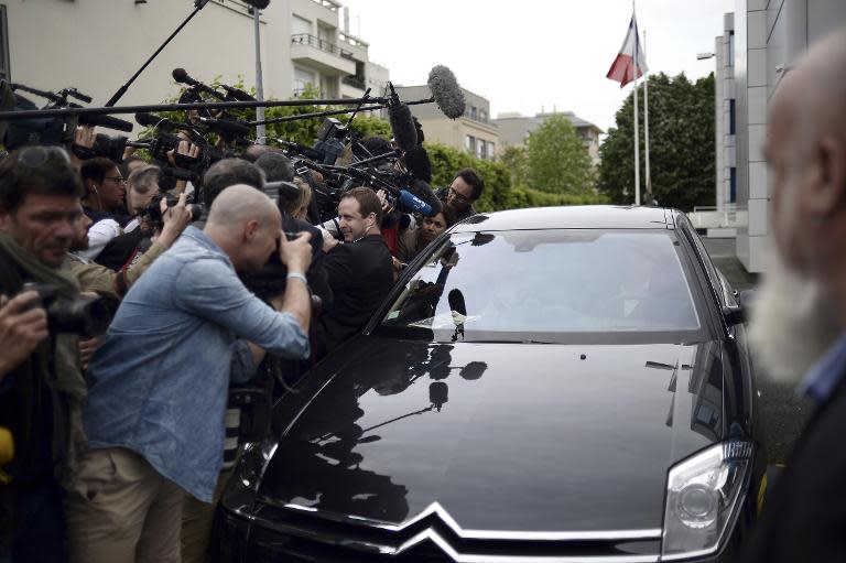 Front National honorary president Jean-Marie Le Pen answers journalists' questions in a car as he leaves the party's headquarters in Nanterre on May 4, 2015