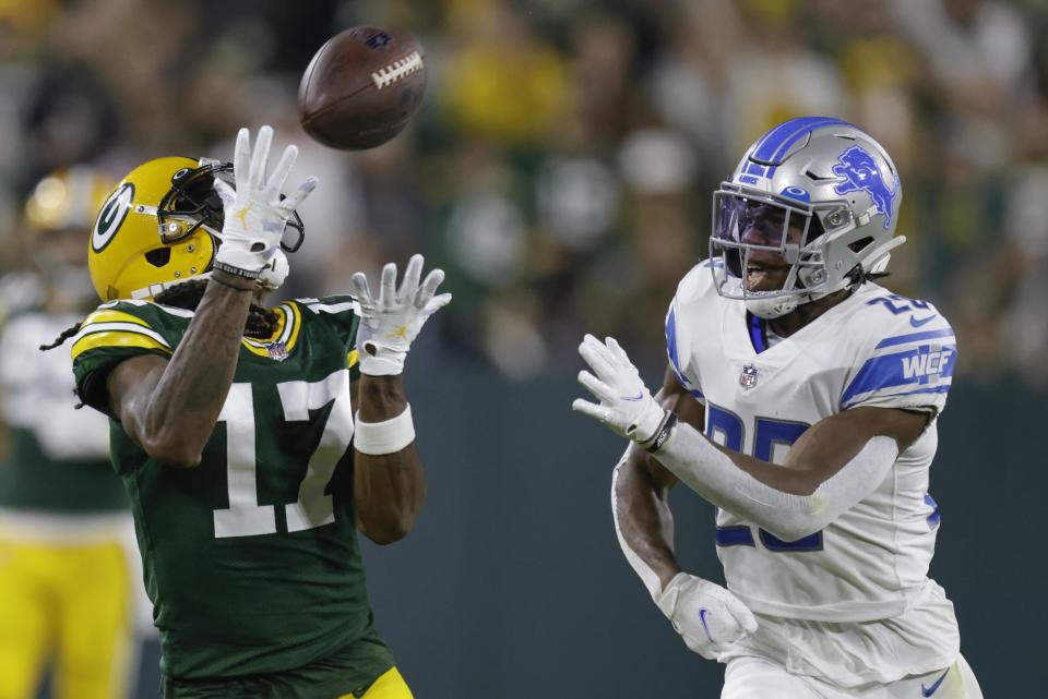 Green Bay Packers' Davante Adams catches a long pass in front of Detroit Lions' Ifeatu Melifonwu during the second half of an NFL football game Monday, Sept. 20, 2021, in Green Bay, Wis. (AP Photo/Matt Ludtke)