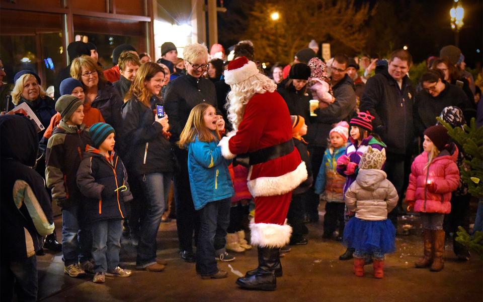 Children react with excitement as Santa Claus arrives for the tree lighting ceremony Dec. 4 as part of the Winter Walk in St. Joseph. 