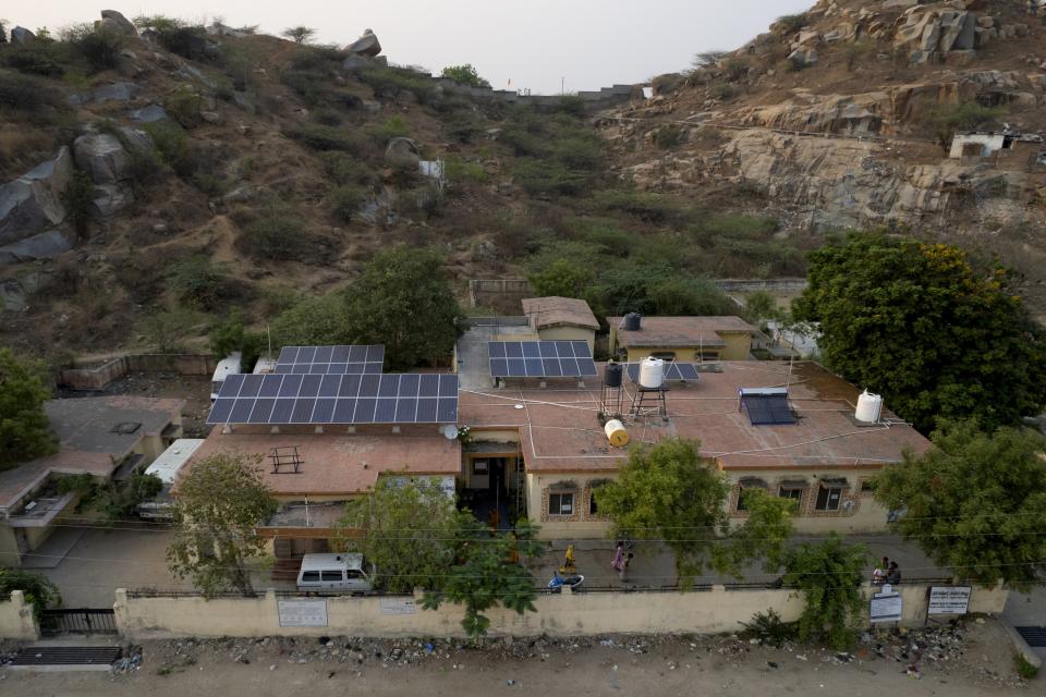 Rooftop solar panels work at a government maternity hospital to provide electricity, in Raichur, India, Wednesday, April 19, 2023. Government Maternity installed rooftop solar panels about a year ago and can now depend on constant electricity that keeps the lights on, patients and staff comfortable and vaccines and medicines safely refrigerated. (AP Photo/Aijaz Rahi)