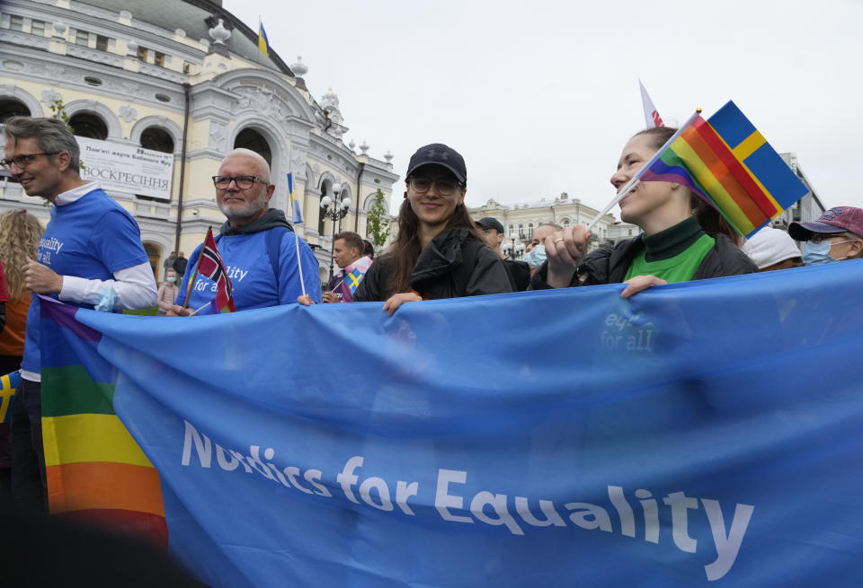 People take part in the annual Gay Pride parade, under the protection of riot police in Kyiv, Ukraine, Sunday, Sept. 19, 2021. Around five thousand LGBT activists and associations paraded in the center of Kyiv. (AP Photo/Efrem Lukatsky)