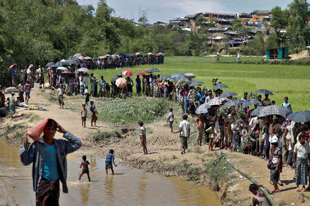 Rohingya refugees queue for aid in Cox's Bazar, Bangladesh, October 1, 2017. REUTERS/Cathal McNaughton