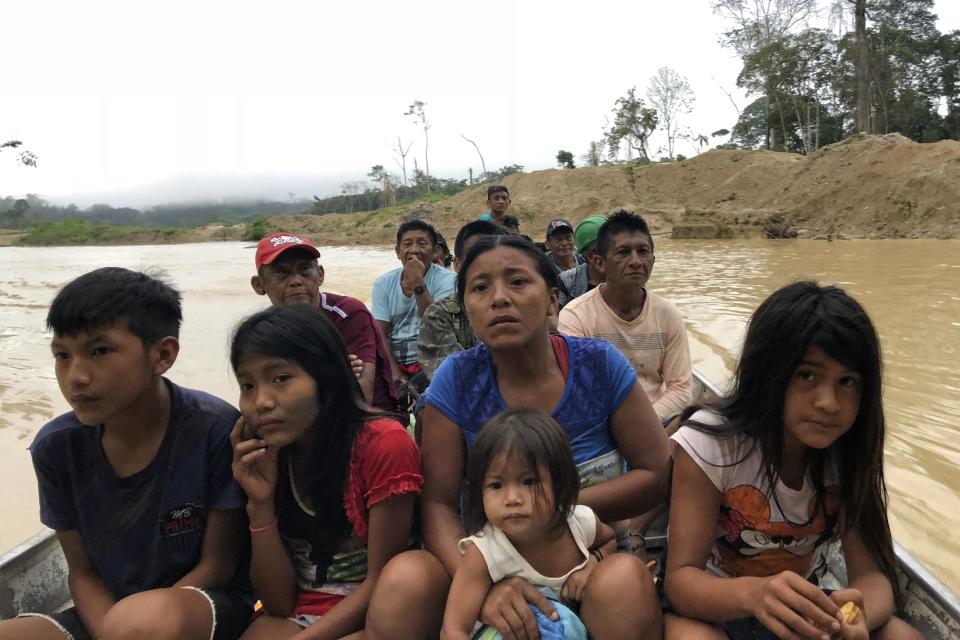 Munduruku ride in a boat amid an illegal gold mining area in Southwestern Para in the Brazilian Amazon, Jan. 26, 2017. Mining has exploded in the region, contaminating hundreds of miles of waterways with debris and mercury. Korap, a Munduruku Indigenous woman from the Brazilian Amazon, has been awarded the prestigious Goldman Environmental Prize for her work fighting against illegal mining and large-scale projects aimed at facilitating soybean exports in the Tapajos River Basin. (AP Photo/Fabiano Maisonnave)