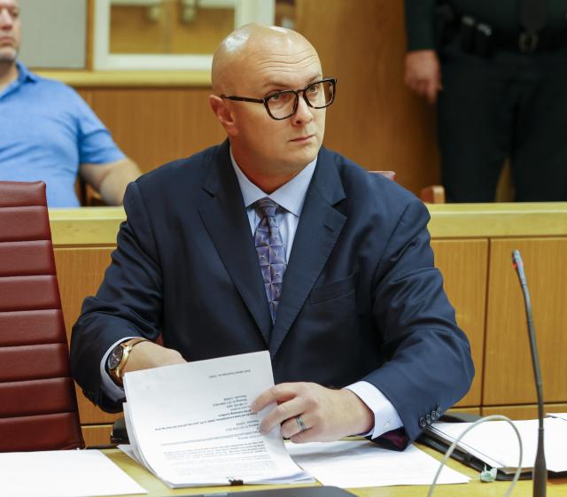 William Braddock looks through papers during a hearing, Tuesday, June 22, 2021, in Clearwater, Fla. Anna Paulina Luna, who plans to run for Florida's District 13 seat after losing a race for the slot in 2020 to Democratic U.S. Rep. Charlie Crist, contends in court documents that GOP challenger William Braddock is stalking her and wants her dead. Luna has filed a petition for a permanent restraining order. Braddock denies the claims and wants to see any evidence against him. (Chris Urso/Tampa Bay Times via AP)