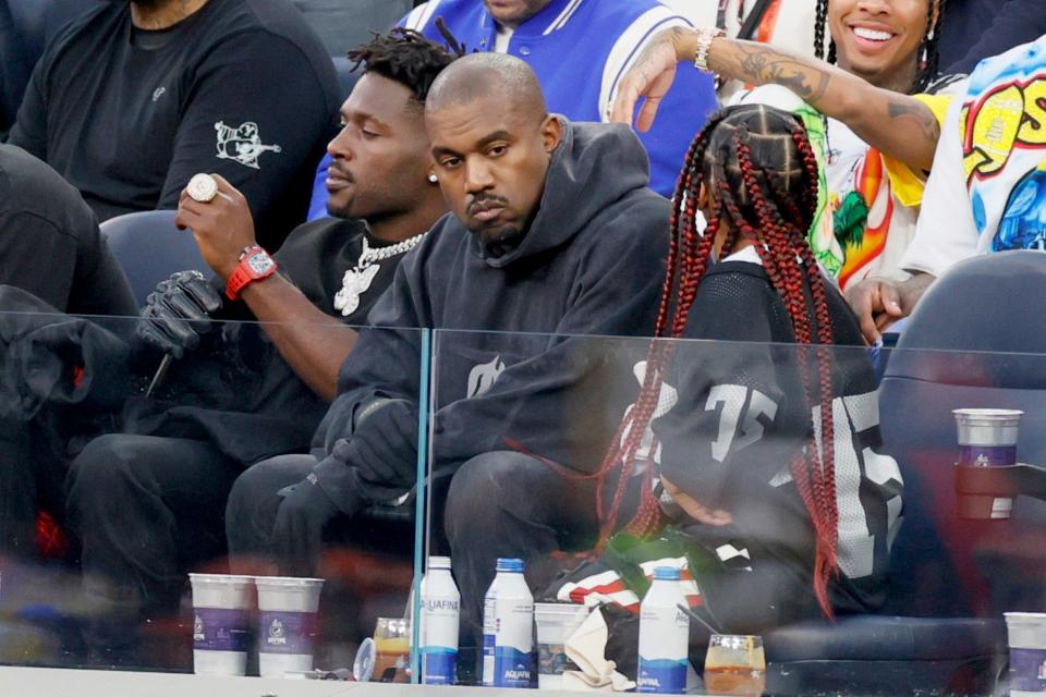 Antonio Brown, Kanye West and North West attend Super Bowl LVI between the Los Angeles Rams and the Cincinnati Bengals at SoFi Stadium.