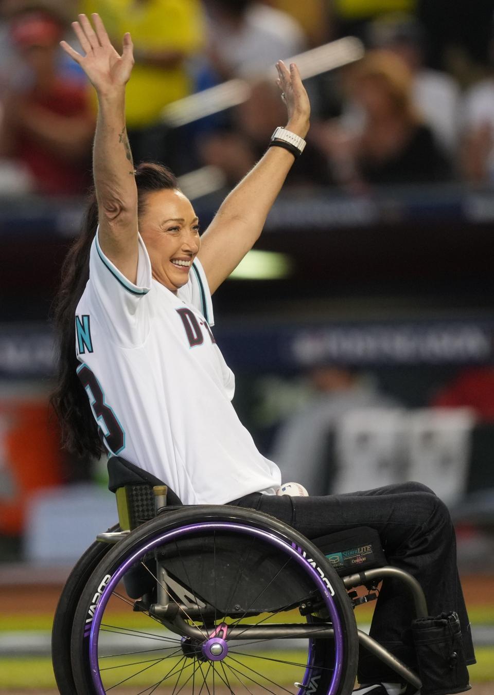 Former Olympic swimmer Amy Van Dyken celebrates after throwing out the ceremonial first pitch before game three of the NLCS of the 2023 MLB playoffs between the Arizona Diamondbacks and Philadelphia Phillies at Chase Field in Phoenix on Oct. 19, 2023.