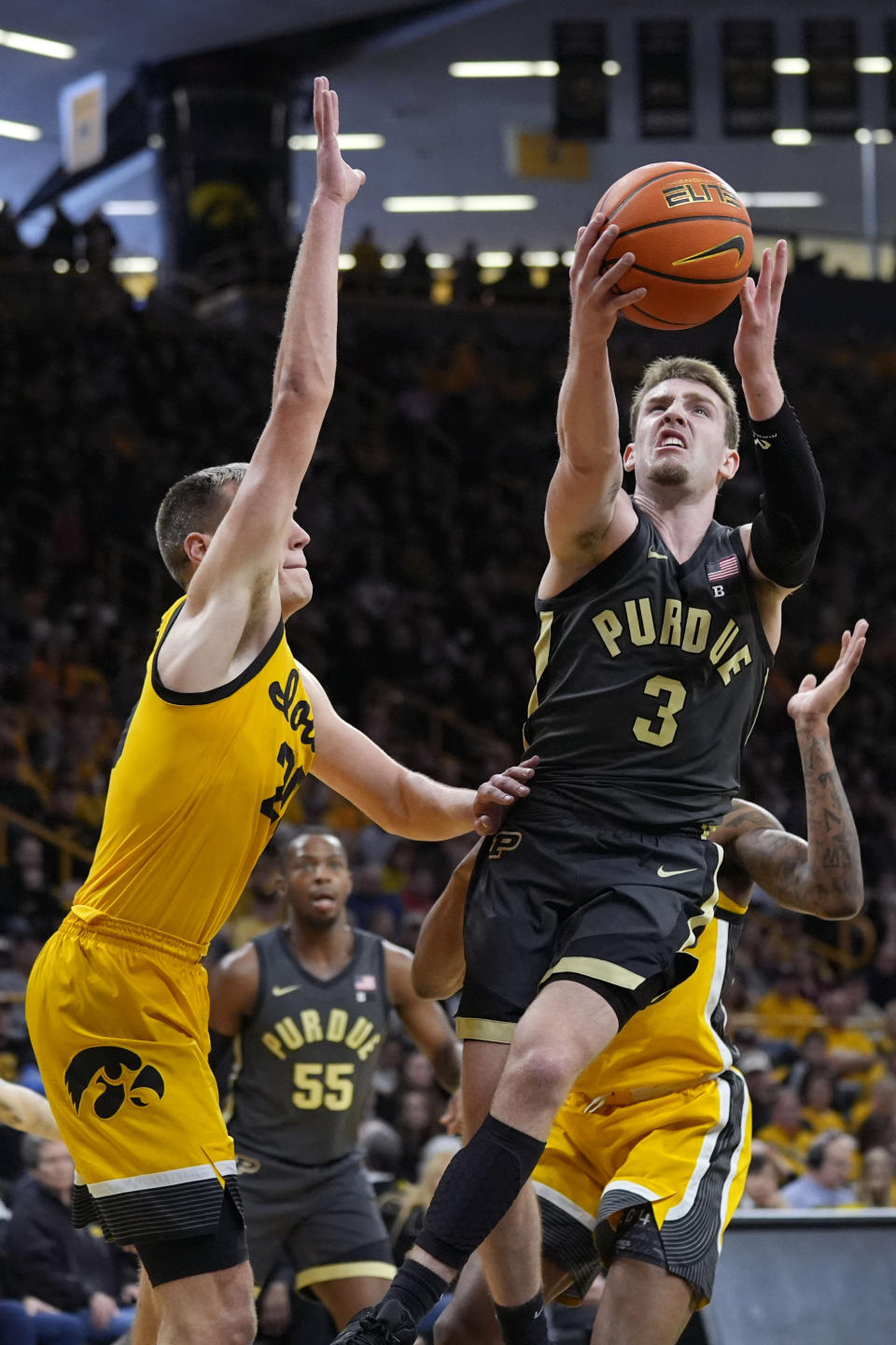 Purdue guard Braden Smith (3) drives to the basket past Iowa forward Payton Sandfort, left, during the first half of an NCAA college basketball game, Saturday, Jan. 20, 2024, in Iowa City, Iowa. (AP Photo/Charlie Neibergall)