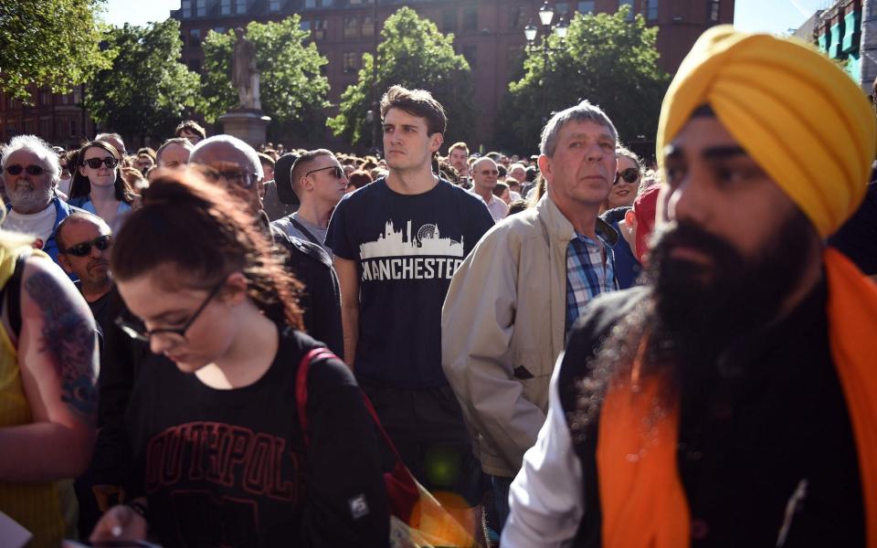 People congregate to attend a vigil in Albert Square - Credit: OLI SCARFF/AFP/Getty Images