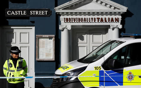 A police officer guards Zizzi's restaurant where Sergei Skripal and his daughter Yulia are known to have visited shortly before they were found in the centre of Salisbury, Britain, March 8, 2018. REUTERS/Peter Nicholls