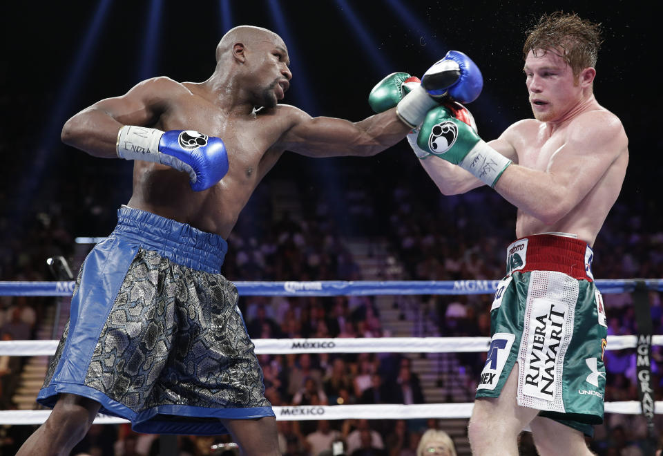 Floyd Mayweather Jr. (L) lands a jab on Canelo Alvarez during their 2013 bout that Mayweather won by decision. (AP)