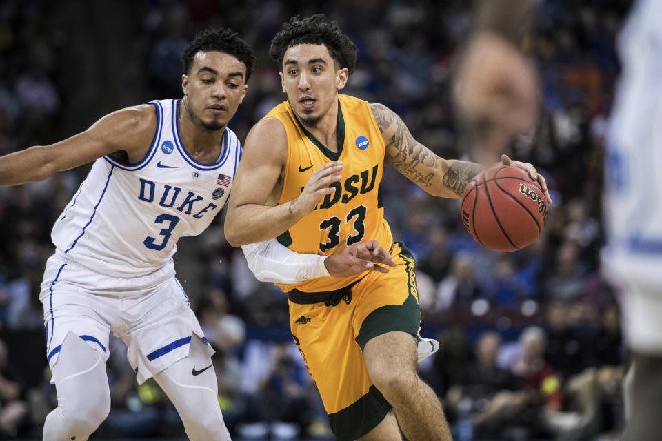 North Dakota State guard Jordan Horn (33) dribbles the ball against Duke guard Tre Jones (3) during the second half of a first-round game in the NCAA men's college basketball tournament Friday, March 22, 2019, in Columbia, S.C. Duke defeated North Dakota State 85-62. (AP Photo/Sean Rayford)