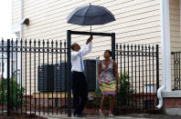 <p>President Barack Obama and first lady Michelle Obama walk through a gate in the Columbia Parc Development to visit newly built homes in New Orleans, Louisiana, August 29, 2010. (Jim Young/Reuters) </p>