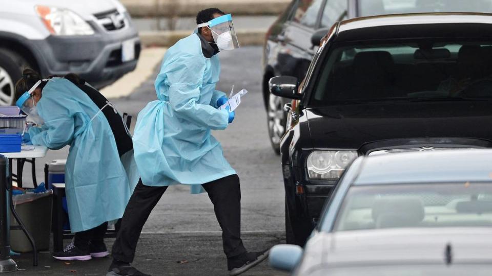 Healthcare workers work to administer and gather COVID-19 test samples and information at STARMED Family & Urgent Care off Freedom Drive and Tuckaseegee Road in Charlotte, NC on Monday, November 31, 2020.