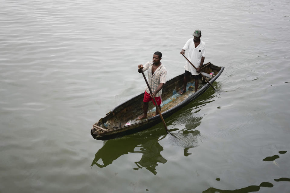 Fishermen arrive to the port of Buenaventura, Colombia, Thursday, Aug. 17, 2023. Colombian President Gustavo Petro aims to rewire how the South American nation addresses endemic violence, replacing military operations with social programs tackling the conflict's roots, including poverty in violence-torn areas like Buenaventura. (AP Photo/Fernando Vergara)