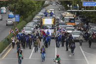 Pro-democracy supporters march along a road during a demonstration in Bangkok, Thailand, Thursday, June 24, 2021. Pro-democracy demonstrators have taken to the streets of Thailand's capital again, marking the 89th anniversary of the overthrow of the country's absolute monarchy by renewing their demands that the government step down, the constitution be amended and the monarchy become more accountable. (AP Photo/Wason Wanichakorn)