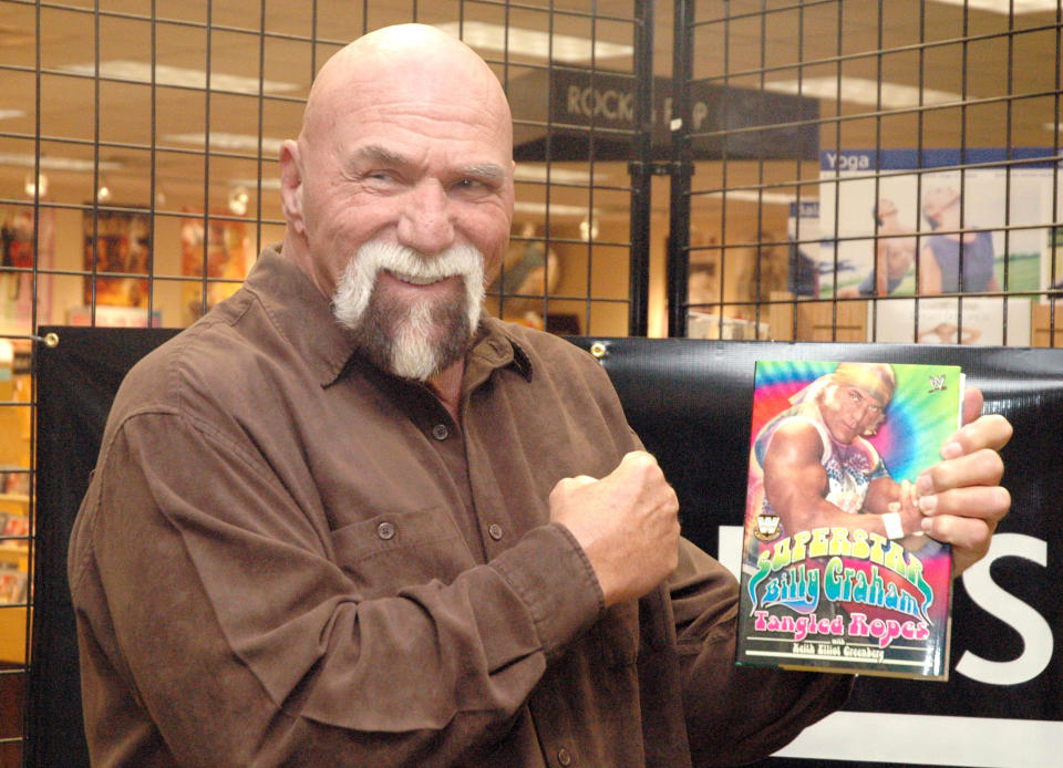 WWE Superstar Billy Graham signs his book 