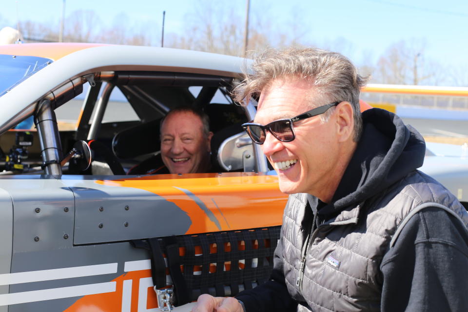 In this March 8, 2021, photo provided by SRX, Ken Scrader, left, laughs with Ray Evernham during SRX testing at Caraway Speedway in Sophia, N.C. The car will definitely not be the star this summer in the Superstar Racing Experience, which has been formatted for drivers to showcase their skills using what series co-founder Ray Evernham calls “old-school tools.” SRX disclosed the format it will use Thursday, May 6, 2021, to The Associated Press when the all-star series launches this summer at Stafford Motor Speedway in Connecticut on June 12 for the first of six Saturday night short-track races across the country. (Garrett Pace/SRX via AP)