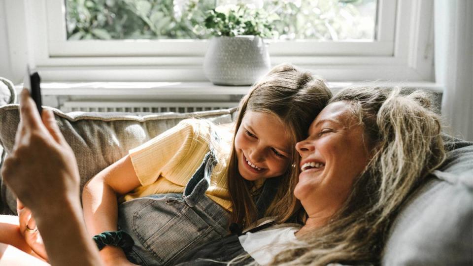 Mom and daughter laughing at Mother's Day Instagram captions