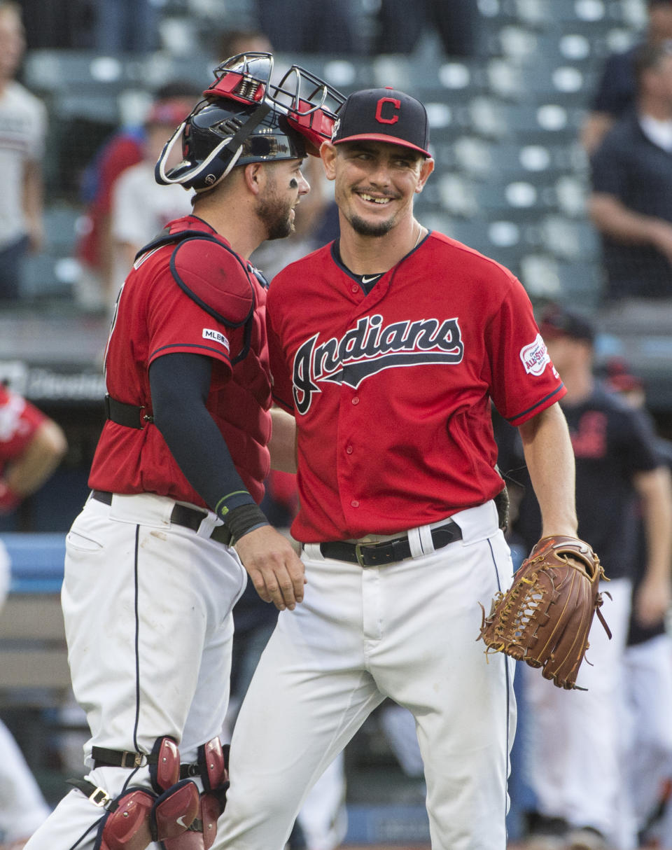 Cleveland Indians relief pitcher Nick Wittgren, right, is greeted by catcher Kevin Plawecki after the team's 5-1 win over the Texas Rangers in the second game of a baseball doubleheader in Cleveland, Wednesday, Aug. 7, 2019. (AP Photo/Phil Long)